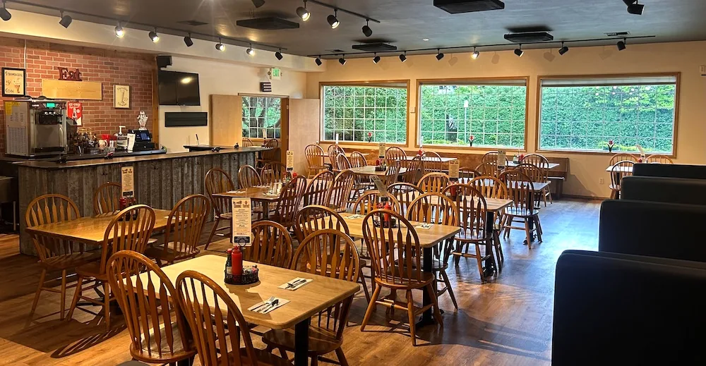 Fanny's banquet room with large windows and warm wood chairs
